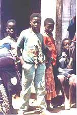 Junge mit zerissenem Hemd am Strassenrand